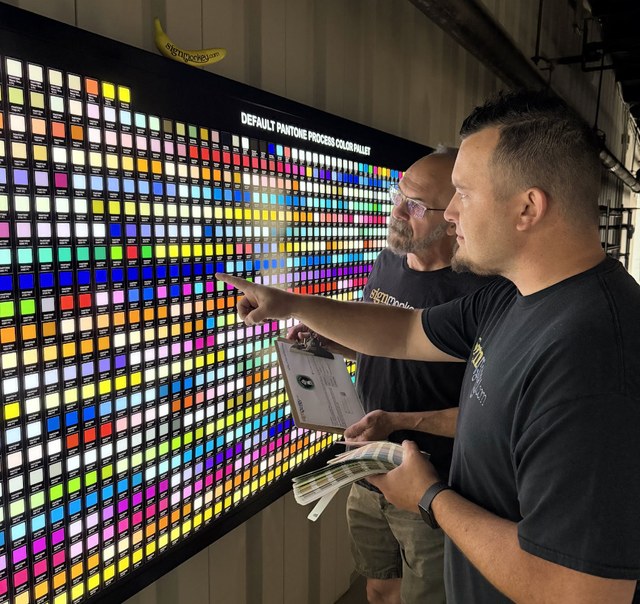 SignMonkey employee reviewing color samples for a custom sign