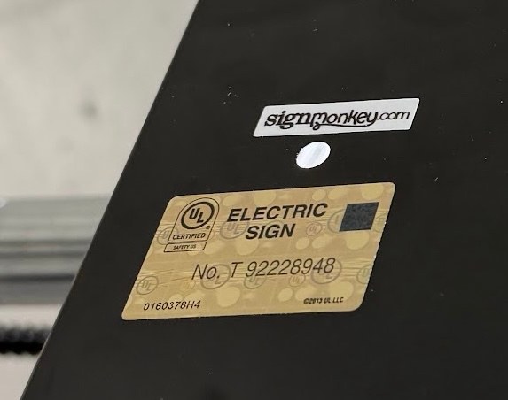 Close-up of a UL certified electric sign label on a SignMonkey sign