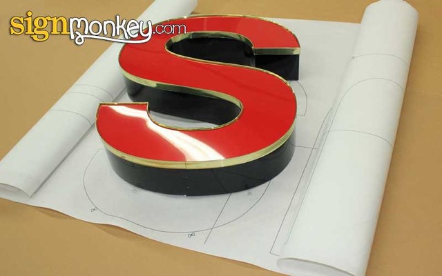 Full-size sign installation pattern taped to a wall