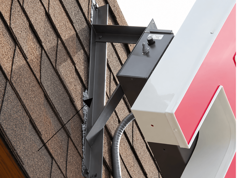 Roof mount bracket installed on a sloped roof with raceway channel letters